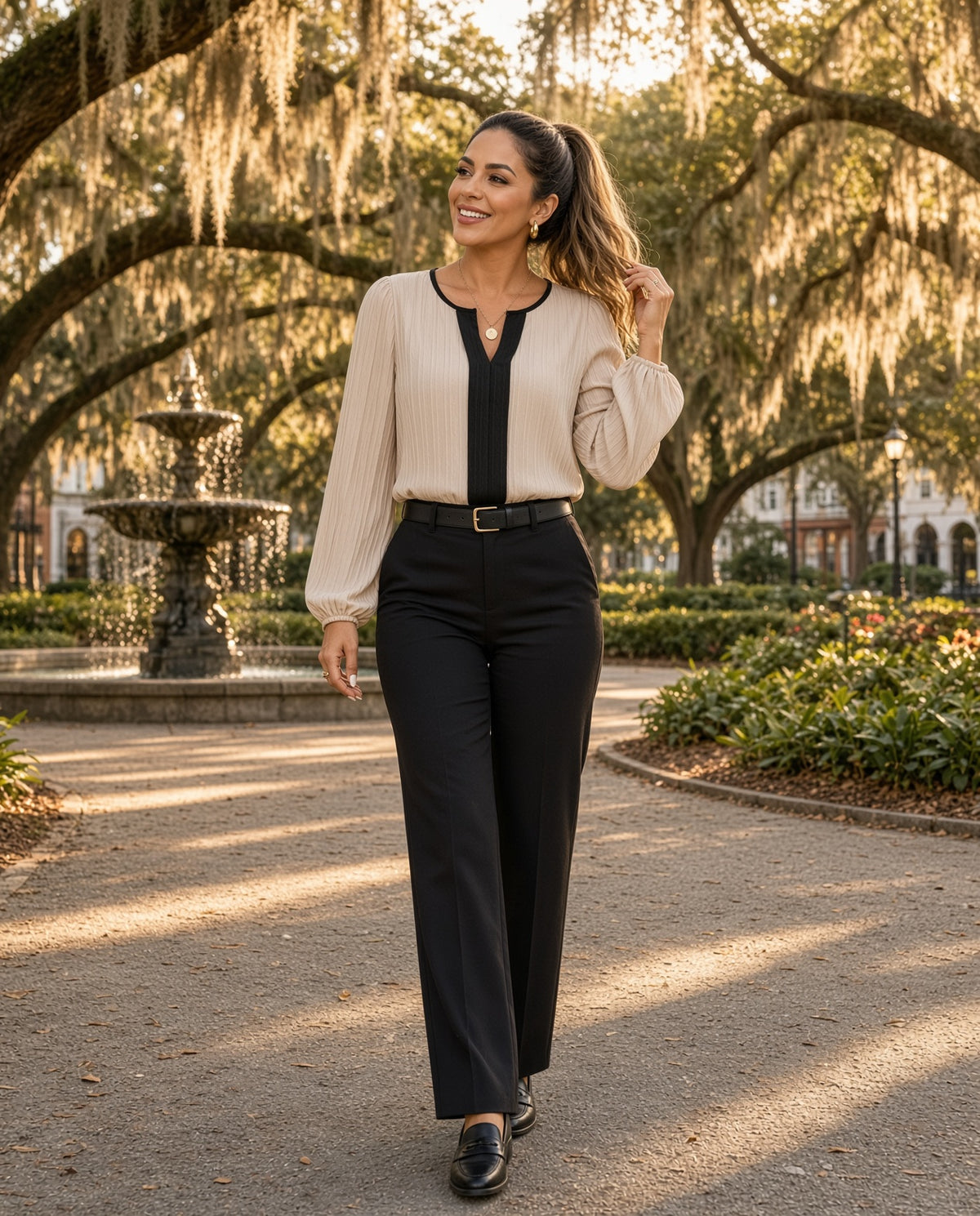 Model wearing the Contrast Notched Long Sleeve Blouse in beige with black trim in a Savannah square