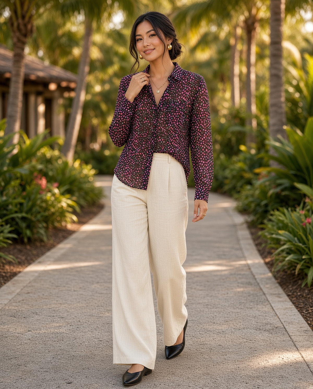 Model wearing the Printed Notched-Neck Long-Sleeve Blouse on a palm-lined resort path