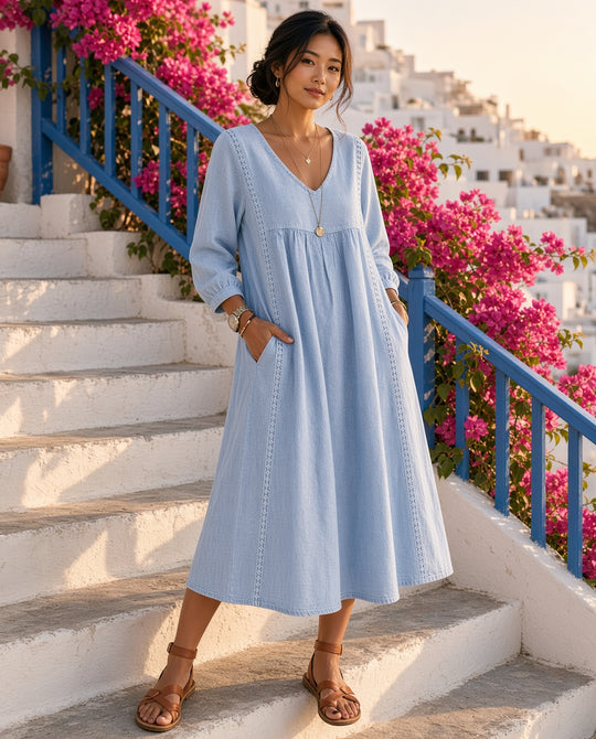 Model wearing the Waimea Lace-Trim Long-Sleeve Midi Dress in Blue on a whitewashed villa stairway with bougainvillea