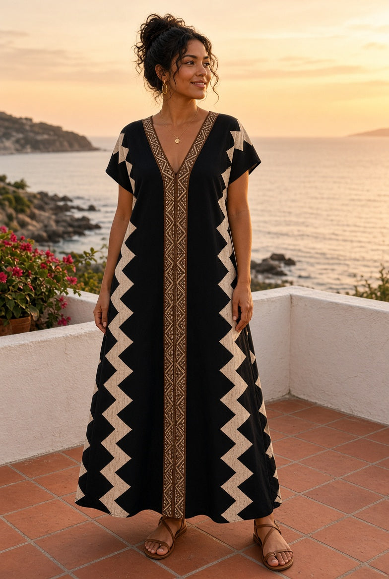 Model wearing the Breezy Batik-Print Maxi Dress in Black on a coastal terrace