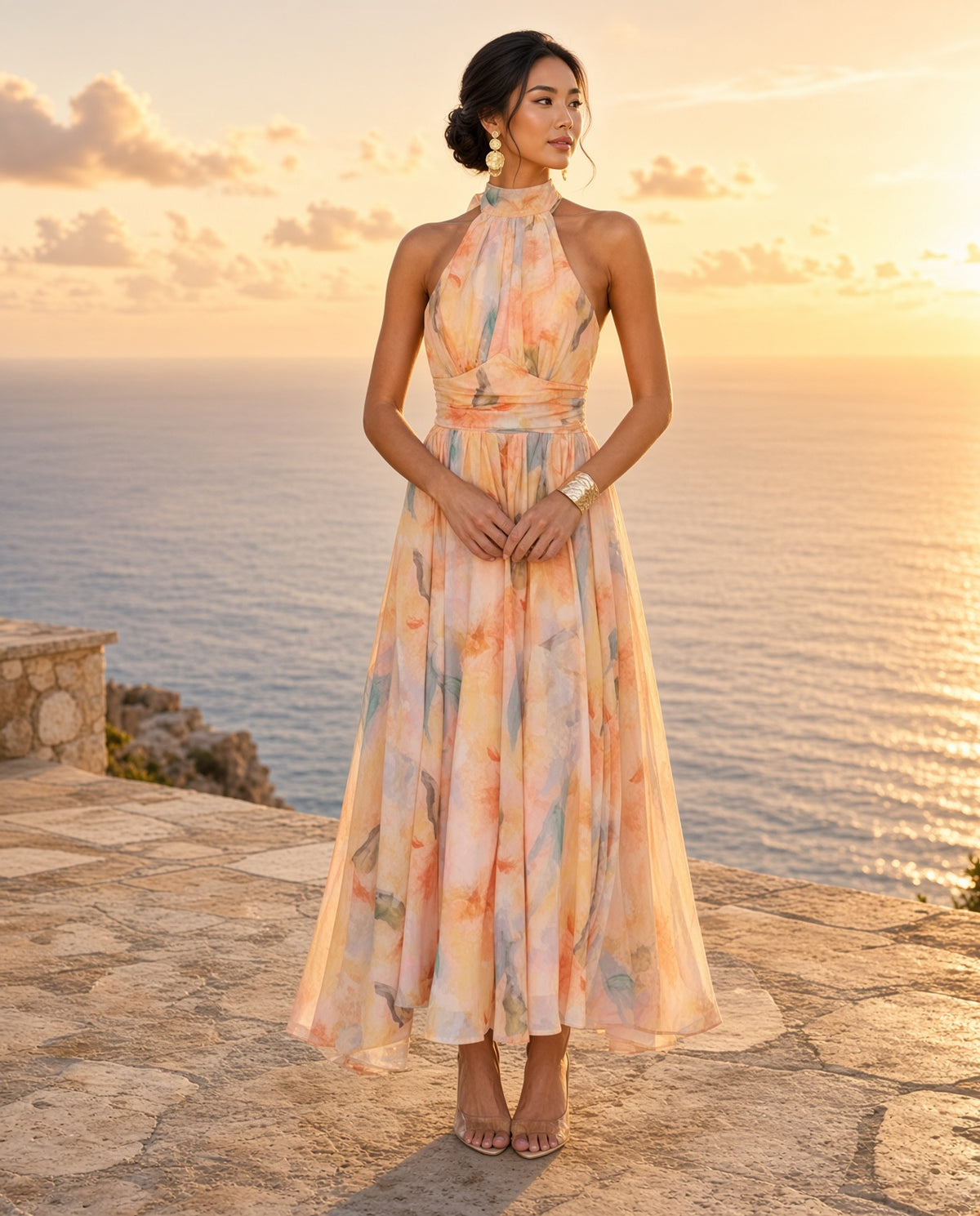 Model wearing the Watercolor Halter Maxi Dress on a coastal terrace